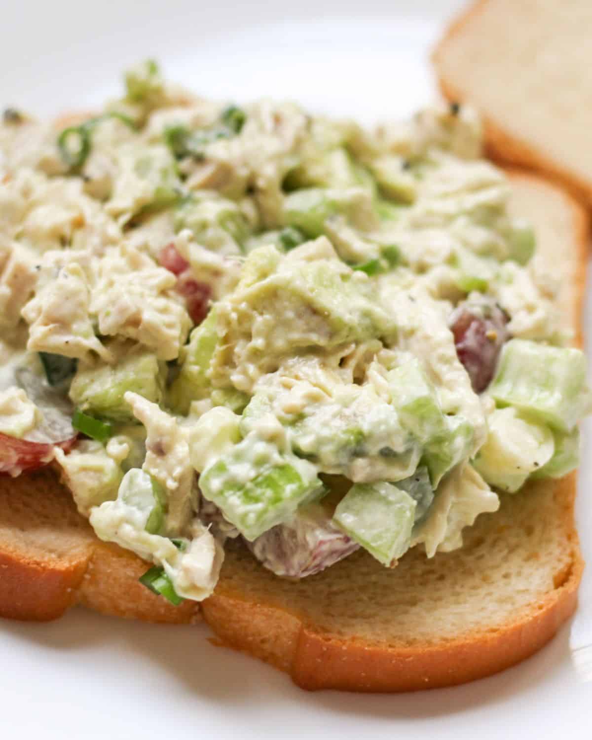A slice of white bread topped with creamy salad.