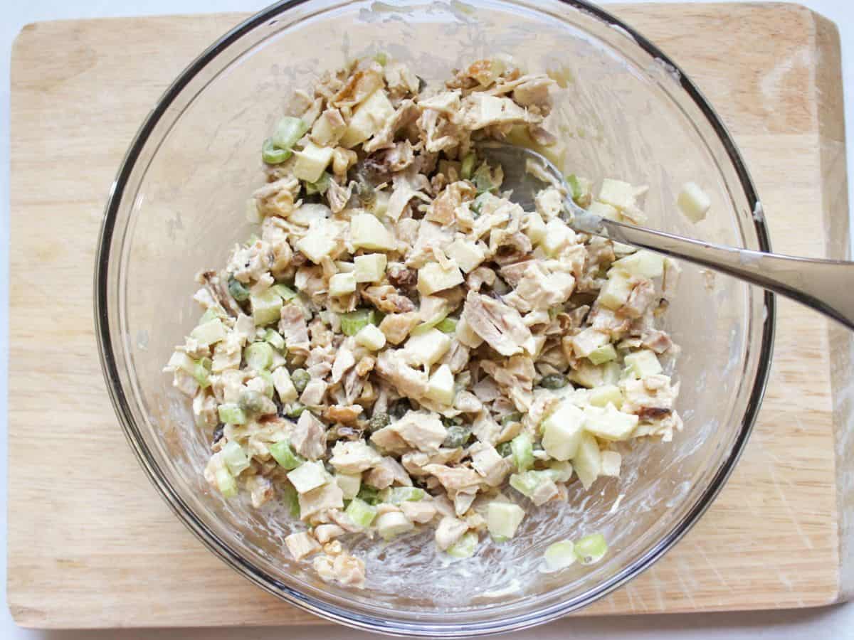 Mixed chicken salad with creamy dressing in a large bowl.