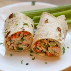 Buffalo tuna salad wrapped in a wheat tortilla and cut in half.