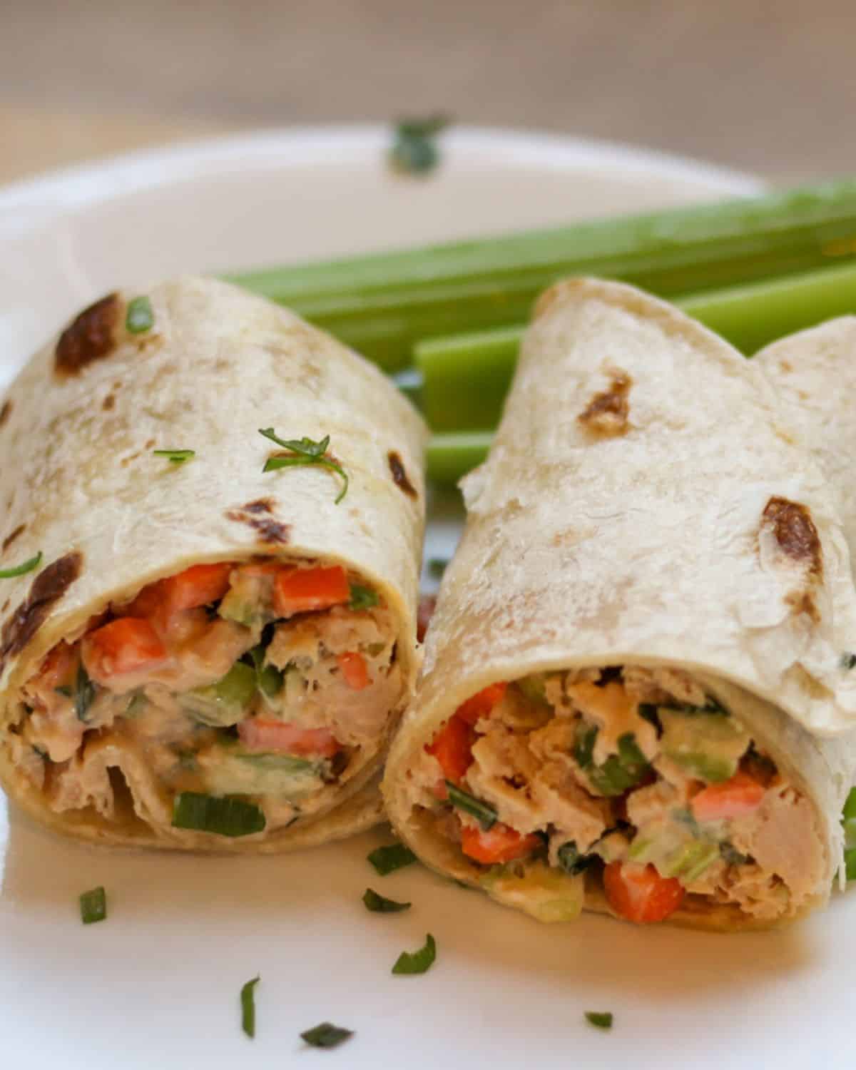 Buffalo tuna salad wrapped in a wheat tortilla and cut in half.