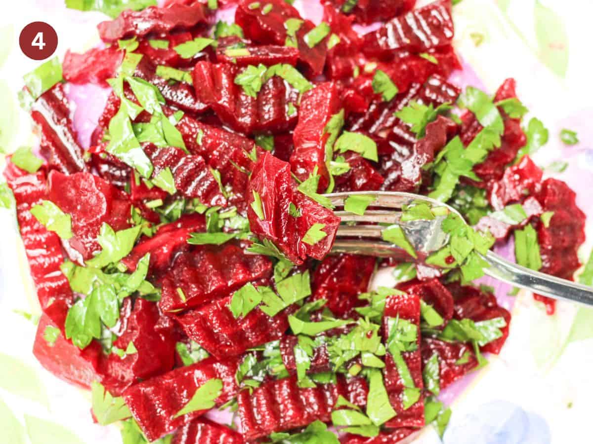 Beetroot salad is assembled and tossed in dressing. 